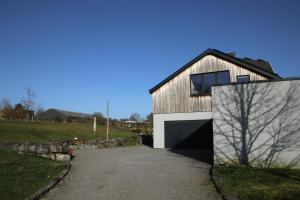 a barn style house with a large garage at Chez Martine & Pierre in Baillonville +31 photos