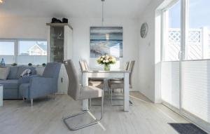 a living room with a table and chairs and a couch at Mein Herzensort in Olpenitz