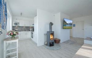a kitchen with a stove in the middle of a room at Mein Herzensort in Olpenitz