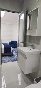 a bathroom with a sink and a mirror and a bed at Los Roires Beach Apartments in Fajardo +101 photos