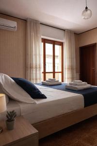 a bedroom with two large beds with a window at ELIOS Grand Apartment in Tropea