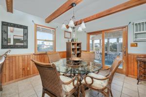 a dining room with a glass table and chairs at 7657 - Dragon's Lair in Avon +16 photos