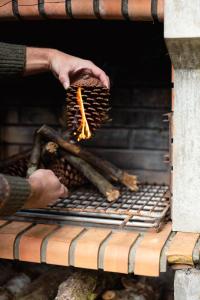 a person holding a bunch of food in an oven at A Finca Hotel in Barreiros +96 photos