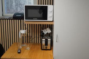 a microwave sitting on top of a table next to a coffee maker at BRABO in Landskrona