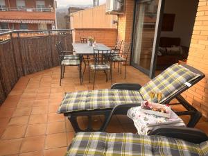 a patio with a table and chairs on a balcony at ACOGEDOR ÁTICO DÚPLEX EN TREMP in Tremp
