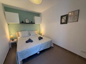 a bedroom with a bed with two hats on it at Le Mazet du Mont Ventoux in Malaucène