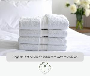 a stack of towels sitting on top of a bed at Le Mazet du Mont Ventoux in Malaucène +17 photos