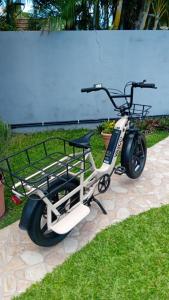 a scooter parked on the grass in a yard at Coin tranquille in Sainte-Anne +2 photos