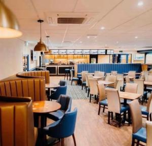 a restaurant with tables and chairs and a kitchen at J&A Caravan in Rhyl