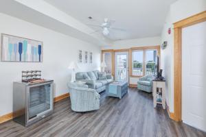 a living room with a couch and a tv at C103A - Sweet Sound Memories in Nags Head