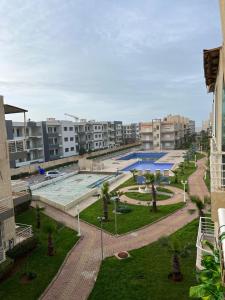 a large swimming pool in a city with buildings at DreamCatcher ocean in Mohammedia