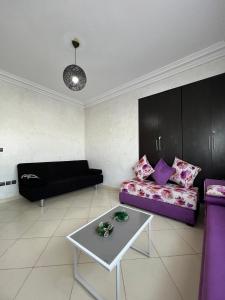 a living room with a couch and a table at DreamCatcher ocean in Mohammedia