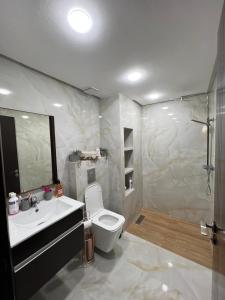 a bathroom with a sink and a toilet and a mirror at DreamCatcher ocean in Mohammedia +19 photos