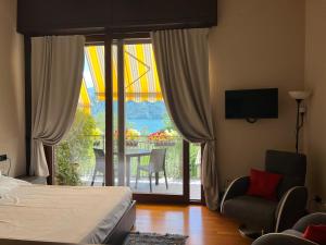 a bedroom with a bed and a view of a balcony at Liza's Suite's - Room's with a View in Sala Comacina +53 photos