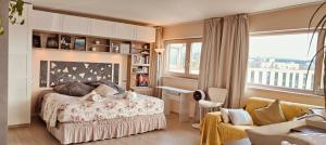 a bedroom with a bed and a large window at Panoramic Luxury Little Penthouse in Florence