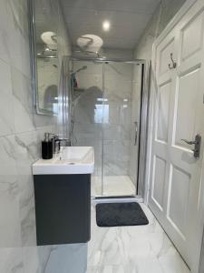 a bathroom with a shower and a sink and a showerspective at Erne View Lodge in Lisnaskea +6 photos