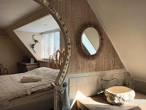 a bathroom with a sink and a mirror at Modern Cozy Asian Style bedroom with Kingsize Spa bath in Westbeemster