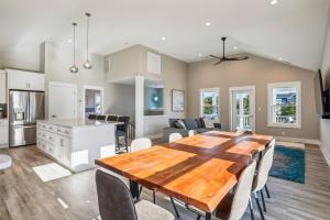 a kitchen and dining room with a wooden table and chairs at 4920 - Stress Less II in Kitty Hawk