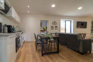 a kitchen and dining room with a table and chairs at Vantage Stays in Gloucester