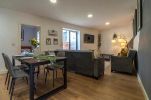 a dining room and living room with a table and chairs at Vantage Stays in Gloucester