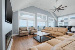 a living room with a couch and a table at 5705 - Edgewater View in Nags Head