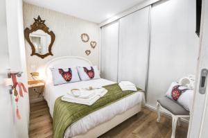 a small bedroom with a white bed and a chair at Lendalima Formosa in Ponte de Lima