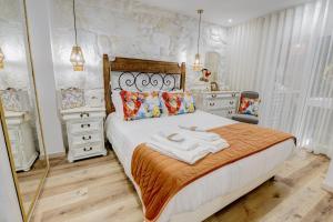 a bedroom with a large bed and a mirror at Lendalima Formosa in Ponte de Lima