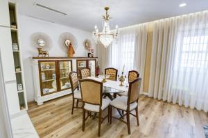 a dining room with a table and chairs and a chandelier at Lendalima Formosa in Ponte de Lima +81 photos