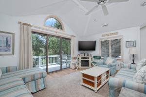 a living room with a couch and a tv at 4603 - Yellow Brick Road in Southern Shores