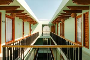 an empty corridor of a building with wooden railing at Luuna de Jade in Oaxaca City +32 photos