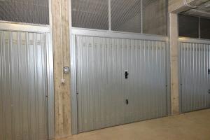 a row of metal garage doors in a building at Eleonora 4A in Temù