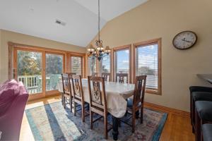 a dining room with a table and chairs and a clock at 3947 - Leg-O Duck in Duck +47 photos