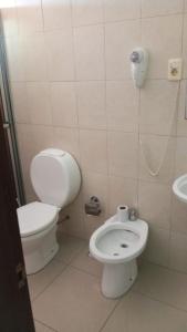 a small bathroom with a toilet and a sink at Natural Agave in Termas del Daymán +12 photos