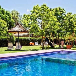 a swimming pool in a yard with a gazebo at Natural Agave in Termas del Daymán