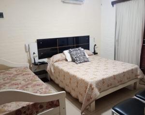 a bedroom with two beds in a room at Natural Agave in Termas del Daymán