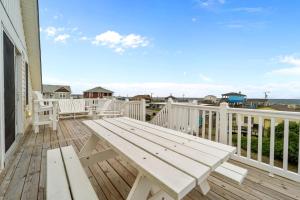 a wooden deck with a bench on a balcony at 4744 - Sandy Beaches in Kitty Hawk Beach