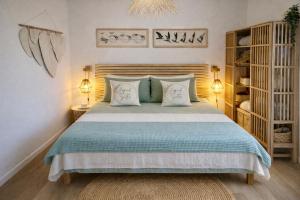 a bedroom with a large bed with two pillows at Japandi Suites Olbia in Olbia