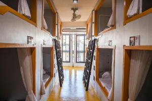 a room with a bunch of bunk beds at The Port Hostel in Surat Thani