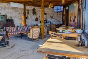 a restaurant with tables and couches in a room at Lubberona Cave Cappadocia in Nar