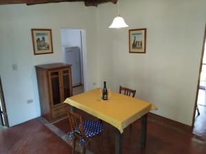 a dining room with a yellow table and chairs at Descanso en Salsipuedes in Salsipuedes