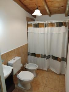 a bathroom with a toilet and a sink at Descanso en Salsipuedes in Salsipuedes