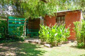 a red brick house with plants in front of it at Descanso en Salsipuedes in Salsipuedes