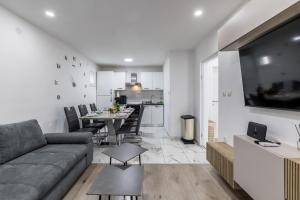 a living room with a couch and a table and a kitchen at Villa Little Heaven in Split