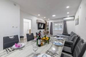 a kitchen and living room with a table and a couch at Villa Little Heaven in Split