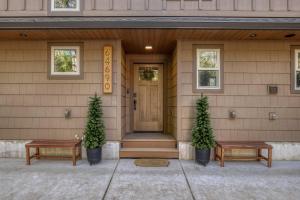 a front door of a house with two benches at Roaring River Lodge Riverfront Fire pit EV Plug in Rhododendron