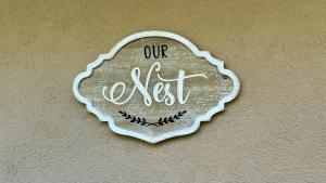 a sign on a wall that says our nest at The Nest in Gainesville