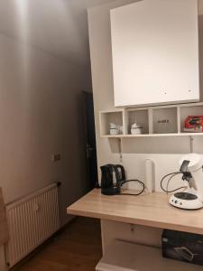 a kitchen with a counter top and a white cabinet at Unterkunft 24 in Aldingen +3 photos