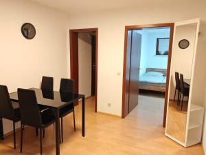 a dining room with a table and chairs and a bedroom at Unterkunft 24 in Aldingen