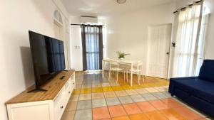 a living room with a flat screen tv and a table at El Castillo Dominicus in La Laguna