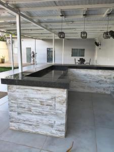 a large room with a counter with a table at Casa Alexandre in Goiânia